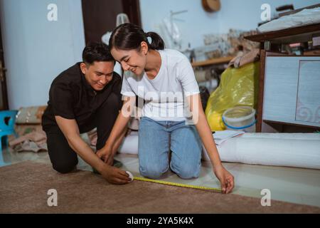 couple of happy asian production crew marking the fabric together Stock Photo