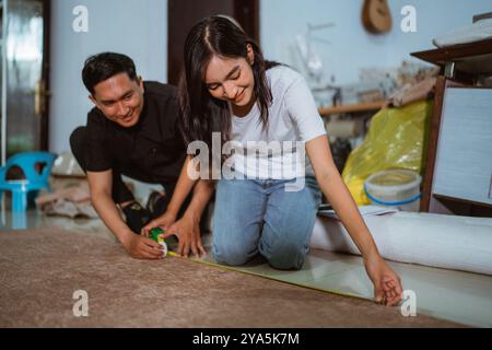 couple of asian production crew marking the fabric material Stock Photo