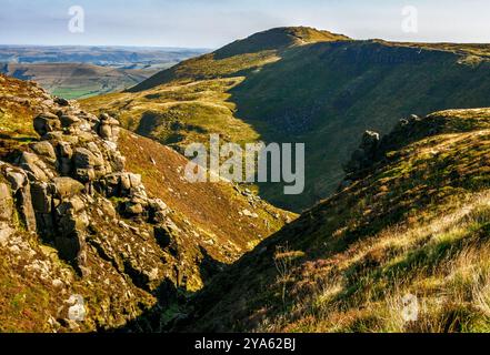 View over Grindsbrook Clough from the brink of the Kinder Plateau looking towards Grindslow Knoll in the Derbyshire Peak District UK Stock Photo