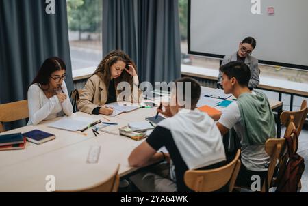Students collaborating in a group study session at school library Stock Photo