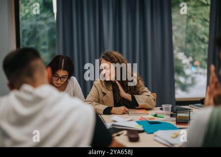 Students collaborating in a lively study group session at school Stock Photo