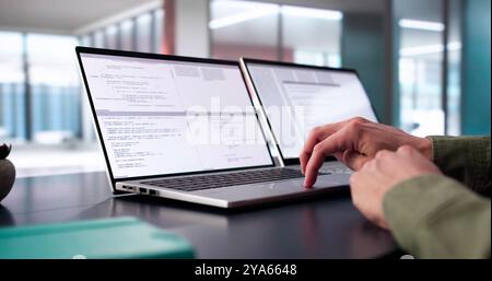 Coder Using Computer At Desk. Web Developer Stock Photo