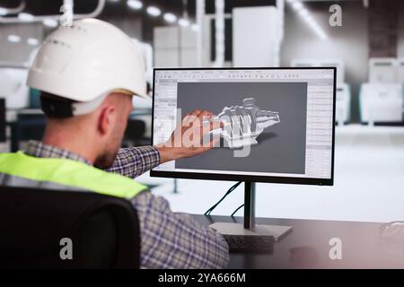 Engineer Doing 3D CAD Model Design On Computer At Factory Stock Photo