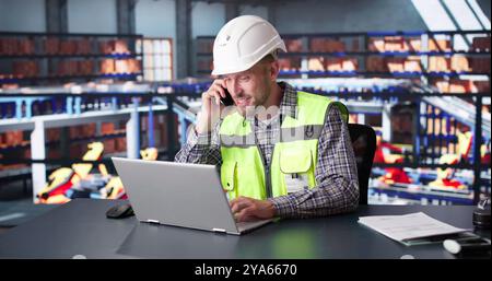 Man Staff In Parcel Delivery Center Using Computer Stock Photo