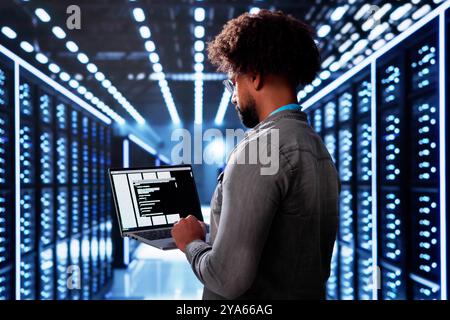 Cloud Computer Engineer Coding In Server Room In Data Center. Configuring AI Technology Stock Photo