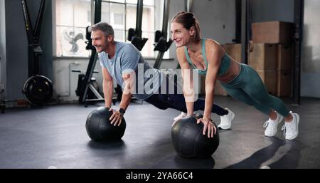 Plank Sport Workout In Gym. Male And Female Fitness Stock Photo