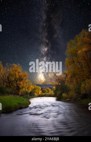 Milkyway galaxy over river with autumn changing leaves Gunnison, Colorado Stock Photo