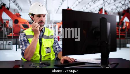 Automobile Vehicle Production Worker Using Walkie Talkie Stock Photo