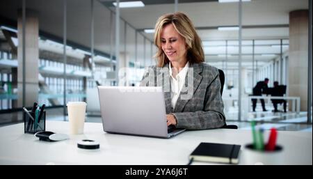 Beautiful Woman Sitting Using Laptop At Office Stock Photo