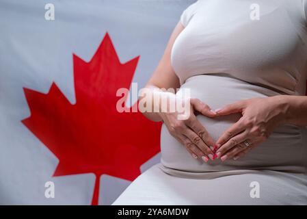 Unrecognizable Future Mother Expecting Baby On Canadian National Flag Background  Stock Photo