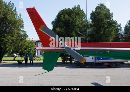 The gray tail rotor of a italian red and green helicopter . Propeller on tail of a red multi-purpose twin-engine helicopter. Stock Photo