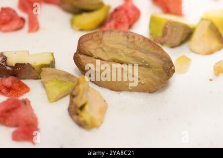 Traditional Easter dinner or brunch with ham, colored eggs, hot cross buns, cake and vegetables. Easter meal dishes with holday decorations. Stock Photo