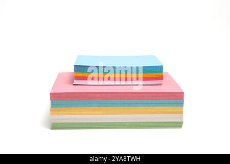 Two stacks of colored paper stacked on top of each other. The paper is cut into different shapes and sizes, creating a visually interesting and playfu Stock Photo