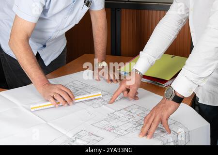 Collaborative Planning Over Detailed Architectural Blueprints for Effective Project Outcomes Stock Photo