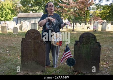 Sleepy Hollow, New York, USA. 12th Oct, 2024. A tour guide speaks about the grave of Catriena Ecker van Tessell, said to have been the inspiration for Katrina van Tassell in Washington Irving's The Legend of Sleepy Hollow on the grounds of the Old Dutch Church in Sleepy Hollow on October 12, 2024 in New York. Sleepy Hollow, the setting for Washington Irving's iconic short story, is famous for its October street fair, its festive decorations and other vibrant Halloween celebrations and is expecting an influx of tourists through Halloween. (Credit Image: © Bryan Smith/ZUMA Press Wire) EDITOR Stock Photo