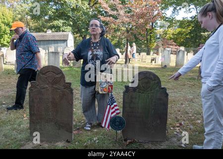 Sleepy Hollow, New York, USA. 12th Oct, 2024. A tour guide speaks about the grave of Catriena Ecker van Tessell, said to have been the inspiration for Katrina van Tassell in Washington Irving's The Legend of Sleepy Hollow on the grounds of the Old Dutch Church in Sleepy Hollow on October 12, 2024 in New York. Sleepy Hollow, the setting for Washington Irving's iconic short story, is famous for its October street fair, its festive decorations and other vibrant Halloween celebrations and is expecting an influx of tourists through Halloween. (Credit Image: © Bryan Smith/ZUMA Press Wire) EDITOR Stock Photo