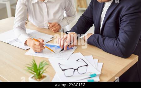 Office business team of male, female employees meeting, analyzing project document text, reports Stock Photo
