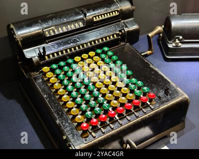 An old fashioned adding machine features a drawer located underneath it Stock Photo