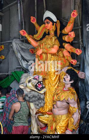 Clay idol of Goddess Devi Durga is in preparation for the upcoming Durga Puja festival at a pottery studio in Kolkata, West Bengal, India on October 0 Stock Photo