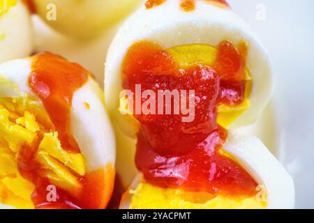 Boiled egg with ketchup and salt. Stock Photo