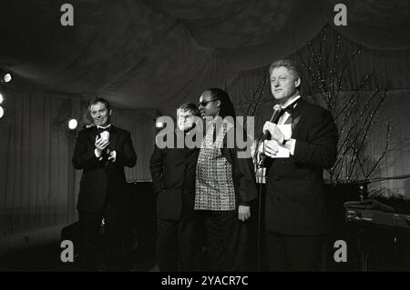 President Bill Clinton and Prime Minister Tony Blair are joined on stage by Elton John and Stevie Wonder following their performance, 1998. Stock Photo