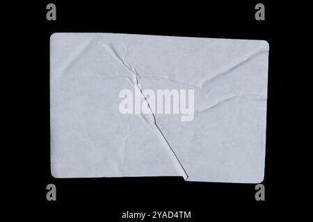 White adhesive glued paper sticker label isolated on black background Stock Photo