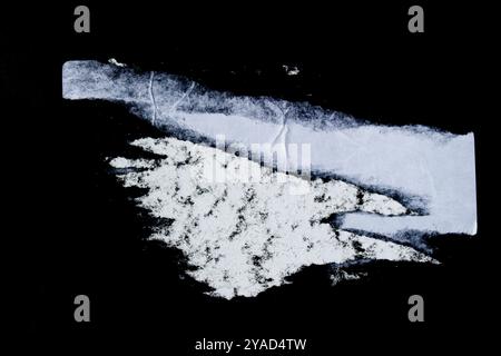 Ripped torn white paper poster sheet isolated on black background Stock Photo