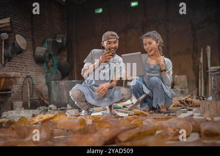 Young artisans collaborate on creative projects in a workshop to enhance skills Stock Photo
