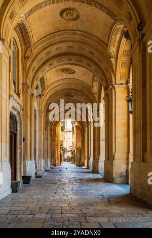 VALLETTA, MALTA - AUGUST 30 2024: Limestone arcade of the National Library in Valletta, known as the Bibliotheca. Stock Photo