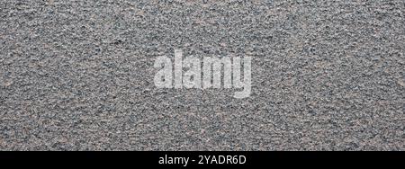 Dark texture of rock. Granite mineral. Rough granite surface pattern, natural mineral stone wall background. Stock Photo