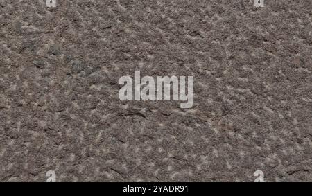 Dark texture of rock. Granite mineral. Rough granite surface pattern, natural mineral stone wall background. Stock Photo