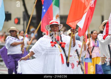 New York, United States. 13th October, 2024. A particiapnt is dancing at the Hispanic Day Parade along Sixth Avenue in New York City. Credit: Ryan Rahman/Alamy Live News Stock Photo