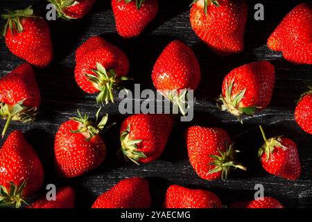 strawberries on black wood background top view Stock Photo