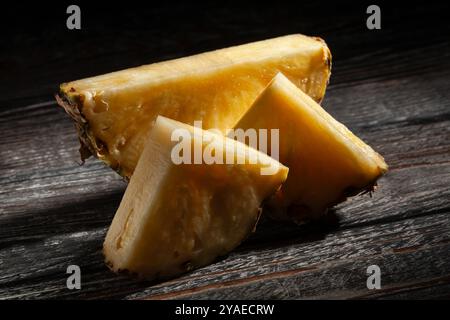 sliced pineapple on black wood background Stock Photo