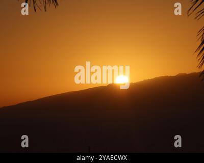Sun going down over the mountain Stock Photo