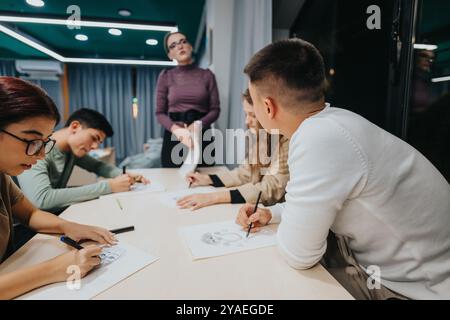 Students actively engaged in a creative classroom drawing session Stock Photo