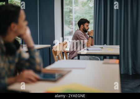 Stressed student preparing for an exam in a quiet classroom Stock Photo