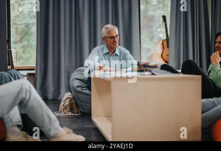 Professor engaging with students in a relaxed classroom setting Stock Photo