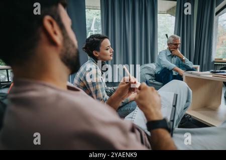 Professor engaging with students in a casual classroom setting Stock Photo