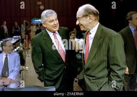 U.S Federal Reserve Chairman Alan Greenspan, right, talks with IBM CEO Louis V. Gerstner, Jr., left, before the start of the Congressional Joint Economic Committee at the start of a three-day summit on high technology and the economy on Capitol Hill, June 14, 1999 in Washington, D.C. Stock Photo