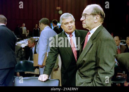 U.S Federal Reserve Chairman Alan Greenspan, right, talks with IBM CEO Louis V. Gerstner, Jr., left, before the start of the Congressional Joint Economic Committee at the start of a three-day summit on high technology and the economy on Capitol Hill, June 14, 1999 in Washington, D.C. Stock Photo