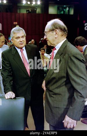 U.S Federal Reserve Chairman Alan Greenspan, right, talks with IBM CEO Louis V. Gerstner, Jr., left, before the start of the Congressional Joint Economic Committee at the start of a three-day summit on high technology and the economy on Capitol Hill, June 14, 1999 in Washington, D.C. Stock Photo