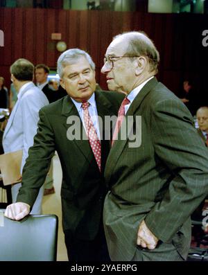 U.S Federal Reserve Chairman Alan Greenspan, right, talks with IBM CEO Louis V. Gerstner, Jr., left, before the start of the Congressional Joint Economic Committee at the start of a three-day summit on high technology and the economy on Capitol Hill, June 14, 1999 in Washington, D.C. Stock Photo