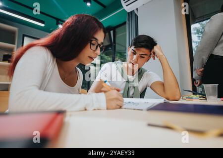Focused students collaborating on creative classroom project Stock Photo