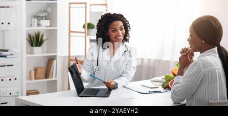 Dietologist using laptop in office, making patient's anamnesis Stock Photo