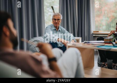 Professor engaging with students in a relaxed classroom setting Stock Photo
