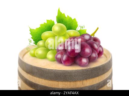 White and red grapes on top of a wooden barrel isolated on white Stock Photo