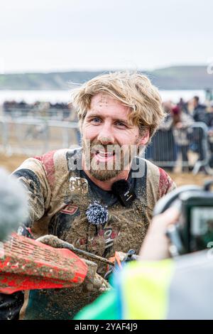 Weston-super-Mare, Somerset, England, UK. 13th October, 2024. JUSTIN BARCIA, after the race covered in sand. This year marks the 41st anniversary of the prestigious Weston Beach Race and it promises to be a spectacular event celebrating over four decades of off-road excellence. Credit John Rose/Alamy Live News Stock Photo