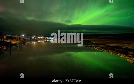 Aurora Borealis over the Inupiaq village of Deering in Northern Alaska Stock Photo