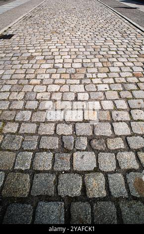 Cobblestone pavement background. Textured background of cobblestone road. Cobblestone pavement for background. Cobblestone road background. Stock Photo